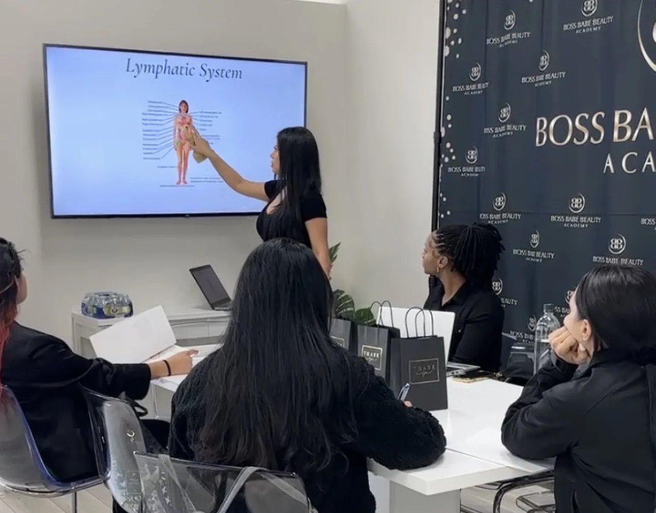 Students training inside a Boss Babe Beauty academy class