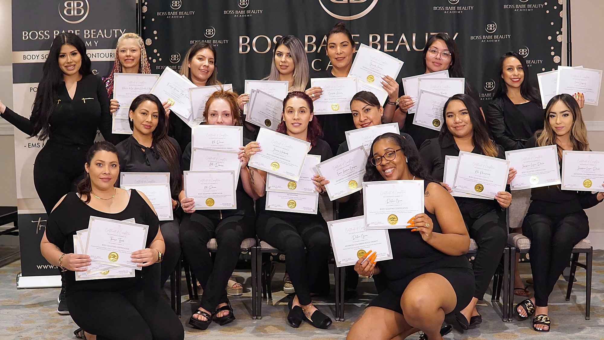 Boss Babe Beauty graduates holding their body-sculpting certification certificates